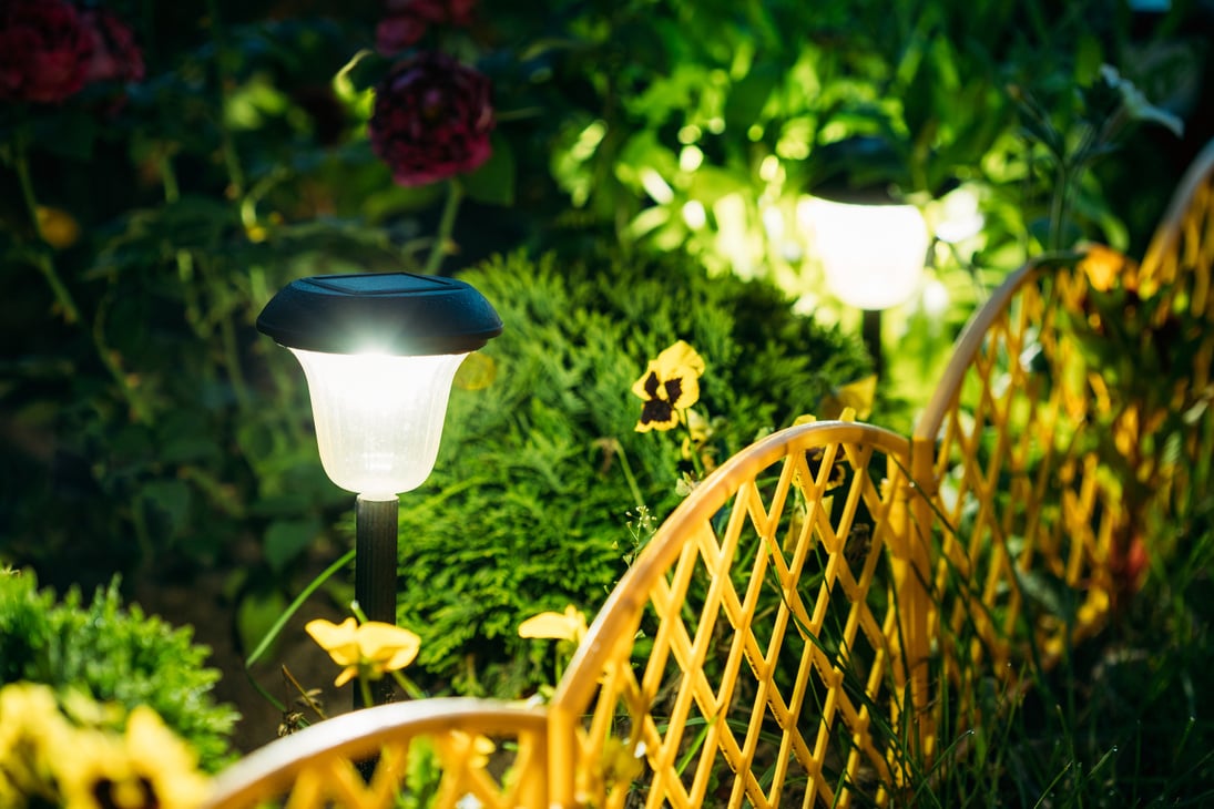Small Solar Garden Light, Lantern In Flower Bed. Garden Design. Solar Powered Lamp